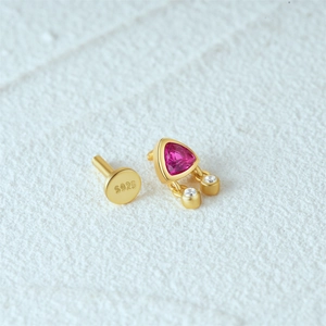Macro detail of S925 sterling silver ear stud with pink stone and S925 hallmark