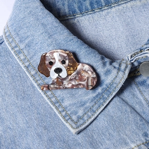 Fashionable dog shaped acrylic brooch pinned on a denim collar for stylish decoration