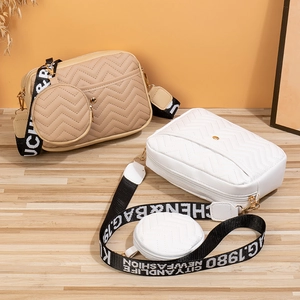 Quilted V-pattern crossbody bags in khaki and white with wide logo straps and coin purses