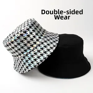Detailed view of reversible bucket hat with laser houndstooth pattern and black canvas side