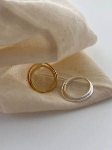 Detail of gold and silver S925 sterling silver multi-layered open rings on linen bag