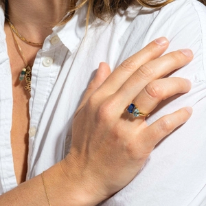 Golden titanium ring with deep blue rectangular and light blue pear-shaped zircon stones