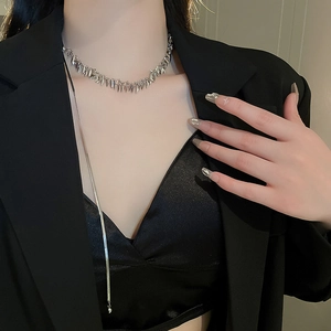 Close-up of silver leaf sequin fringe choker necklace on a model wearing black blazer