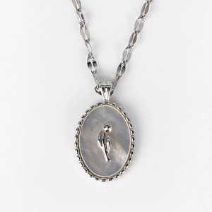 Macro view of vintage silver shell necklace with tulip relief and beaded edge