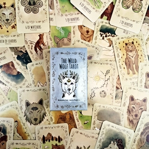 Macro detail of The Wild Wolf Tarot deck cards featuring hand-drawn wolf illustrations