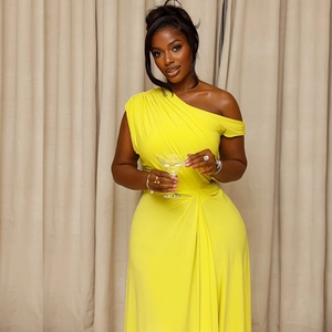 Detail of waist pleats and cinched silhouette on this yellow one-shoulder maxi dress