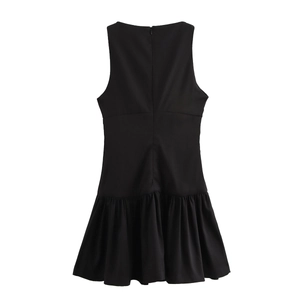 Detailed view of back zipper closure and ruffled hem on black sleeveless dress