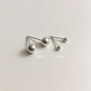Detail view of 3mm and 5mm minimalist sterling silver ball stud earrings set
