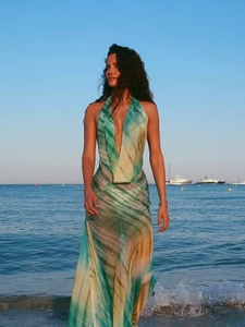 Detail of tropical tie-dye backless halter dress featuring a deep V-neck and flowing fabric