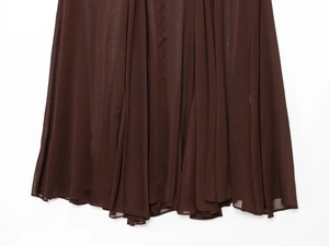 Close-up of dark brown sheer chiffon fabric with detailed pleats and elegant drape texture