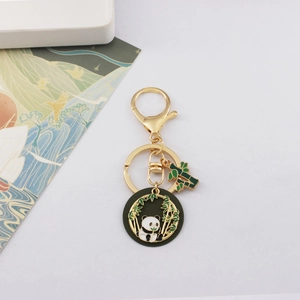 Detailed view of the cute panda and bamboo gold-plated metal keychain with enamel finish