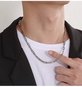 Silver paperclip link necklace styled on a model wearing a black blazer and white tee