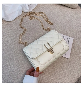 Detail of cream quilted chain bag with gold Y-lock and premium faux leather texture