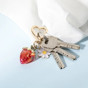 Cute strawberry heart keychain with white daisy charm and golden heart-shaped hook