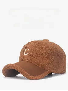 Close-up of brown teddy fleece texture and white letter C embroidery on the baseball cap