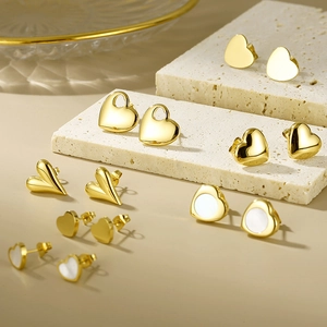 Detailed view of heart-shaped 18K gold plated stainless steel stud earrings set