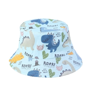Close-up of light blue kids bucket hat featuring colorful cartoon dinosaur prints