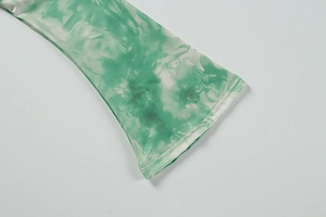 Detailed close-up of flared sleeves with green and white marble tie-dye pattern sewing