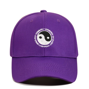 Close-up of Yin Yang embroidery and Swimming text on purple cotton baseball cap