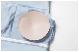 Detail view of breathable sport dress featuring removable pink round bra pads inside