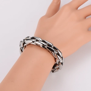 Vintage stainless steel braided chain bracelet for men displayed on a model hand