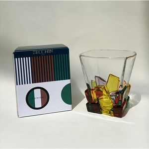 Detailed view of hand-painted Zecchin crystal whiskey glass and branded gift packaging