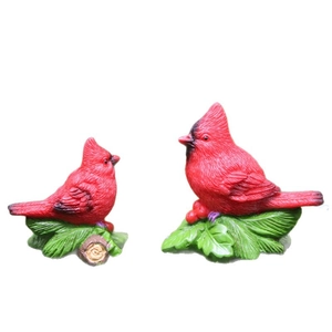 Set of two resin cardinal bird figurines with holly leaf and red berry bases for decor
