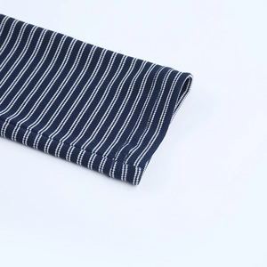 Detail of navy blue and white striped knit fabric with high-quality ribbed cuff stitching