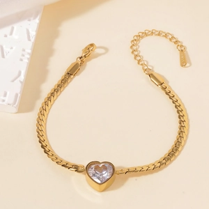 Detail of gold stainless steel bracelet with heart zircon and lobster clasp closure