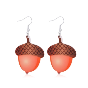Detailed view of acorn earrings with reddish-brown caps and orange resin fruits on silver hooks