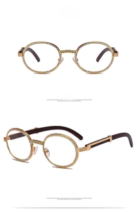 Detail of round gold glasses with colorful rhinestones and brown wood grain temples