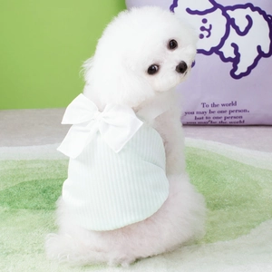 Detail of mint green pet summer top with a large white bow and ribbed knit texture