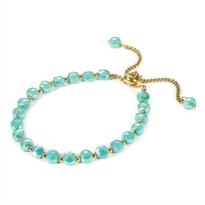 Detailed shot of aqua green faceted beads and gold spacers on an adjustable bracelet