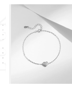 Detailed close-up of S925 sterling silver bracelet with micro-set heart pendant