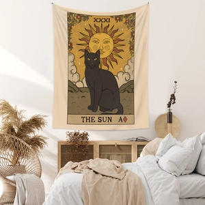 Detail view of Bohemian sun and black cat tarot tapestry hanging in a cozy bedroom