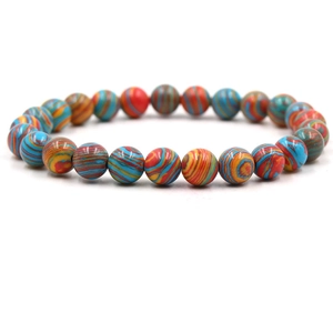 Macro shot of colorful round striped malachite beads on an elastic handmade bracelet