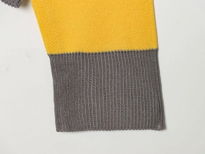 Detail of ribbed knit cuffs showing high-quality gray and yellow patchwork stitching