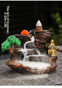 Macro detail of incense burner showing resin landscape mountain with flowing smoke effect