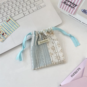Detail of floral lace drawstring bag with retro pastoral pattern and Sozakka label