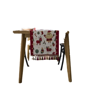 Christmas table runner with Santa Claus, reindeer and festive tassels on white background