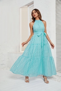 Detail view of light blue halter neck maxi dress with ruffled tiers and waist tie