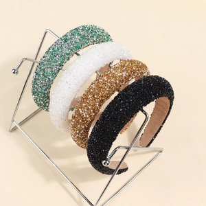 Set of four wide sponge headbands with pearls and rhinestones in green white gold and black