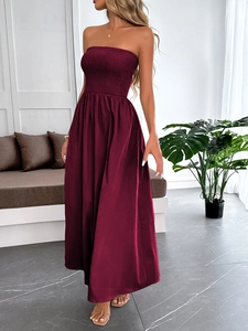 Detail of burgundy strapless maxi dress with shirred bodice and flowing A-line skirt