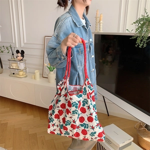 Detail of red rose floral tote bag with rope handles and Sozakka brand woven label