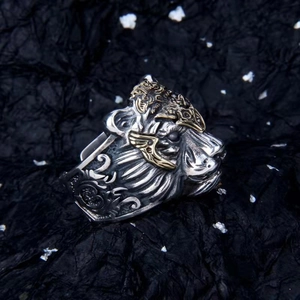 Detail of vintage silver lion head ring with gold crown and intricate engraved mane textures
