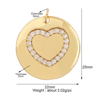 Macro shot of 22mm gold round pendant with micro-pave heart center on white backdrop