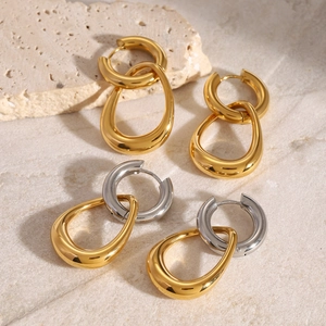Detailed close-up of double-loop nested hoop earrings in gold and silver finish