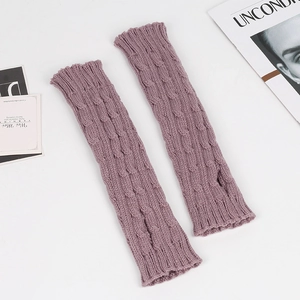 Detail of dusty pink cable knit arm warmers with thumb holes and textured wool pattern
