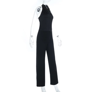 Side view of black halter neck jumpsuit with cinched waist and straight leg trousers