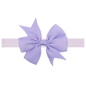 Close-up of a large purple grosgrain ribbon bow on a soft elastic baby headband